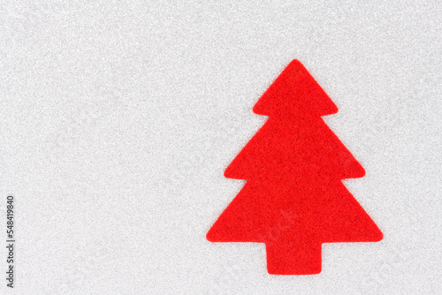 A red christmas tree on a silver background