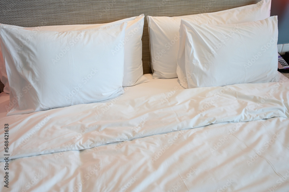 white bed and pillows in the room