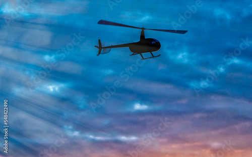 Fototapeta Naklejka Na Ścianę i Meble -  Helicopter silhouette with sunset sky on the background.