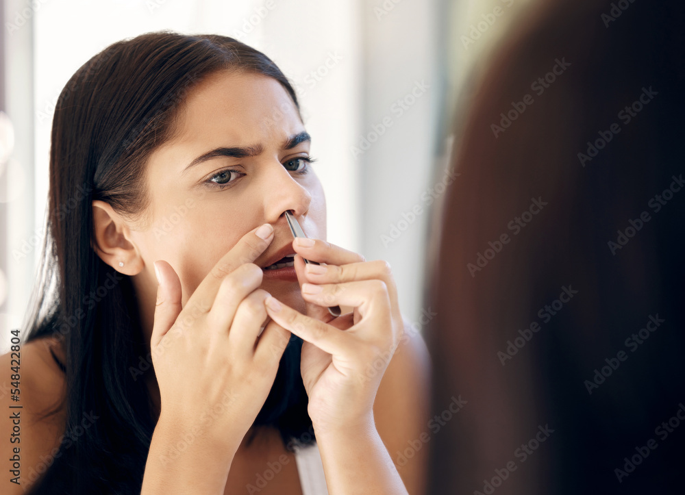 Face, nose and beauty with a woman using a tweezer to remove nasal hair