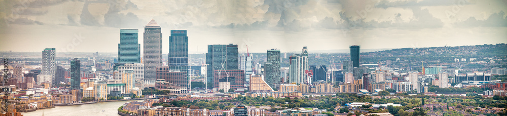 London - UK. Aerial panoramic view of Canary Wharf modern buildings on a cloudy day
