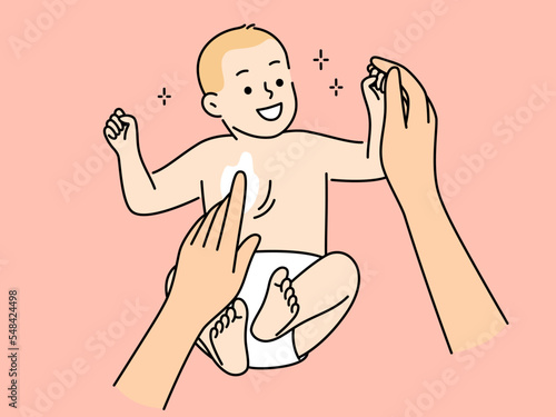 Mother apply cream on newborn baby 