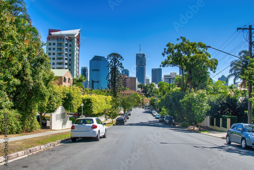 City street and parked cars near the city center on a sunny day - Brisbane, Queensland © jovannig