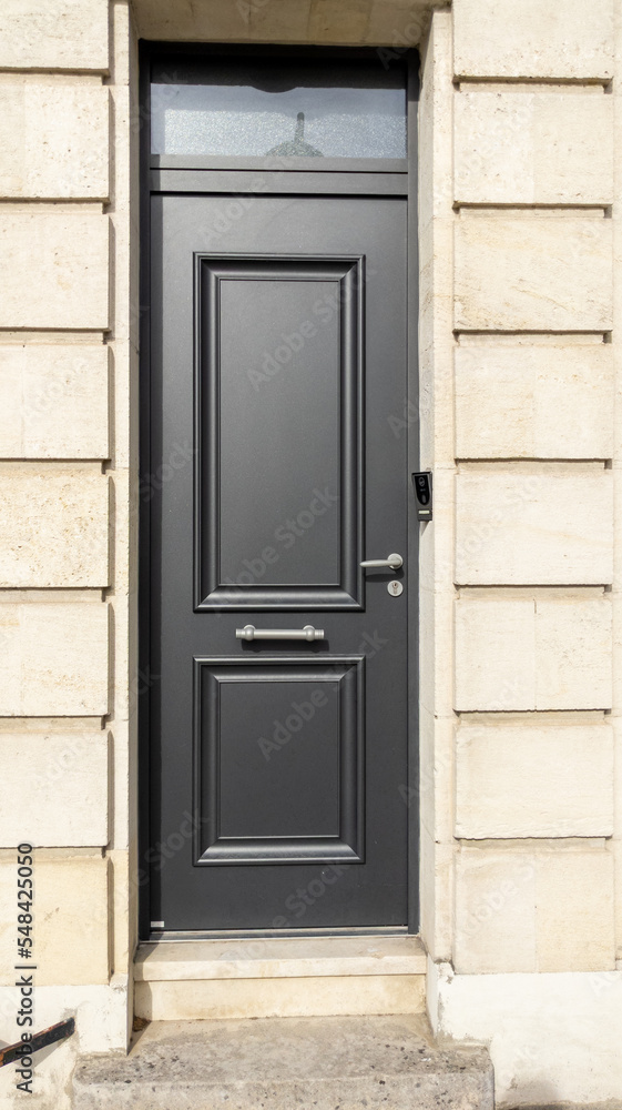 Wooden high door grey modern on french wall gray city street classic stone facade