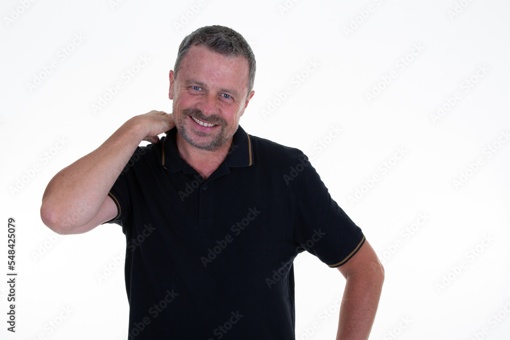 Handsome middle aged man in studio portrait with hands arms on head neck on white wall background Handsome middle aged man in studio portrait with hands arms on head neck on white wall background