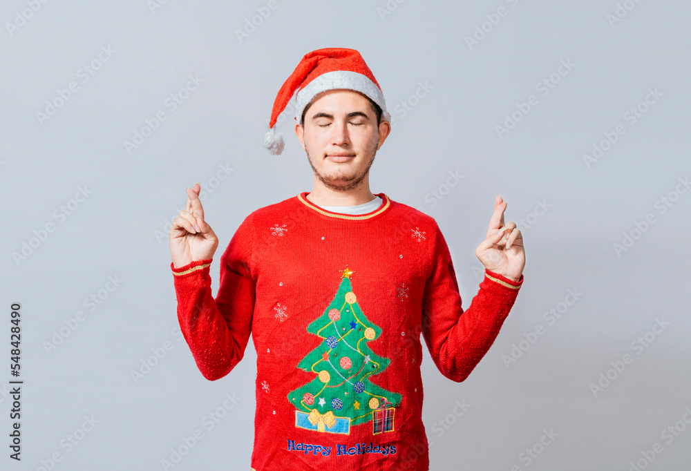 Hopeful man in christmas clothes making a wish, Handsome man in christmas hat making a wish on white background, Guy with christmas hat making a wish on isolated background Hopeful man in christmas clothes making a wish, Handsome man in christmas hat making a wish on white background, Guy with christmas hat making a wish on isolated background