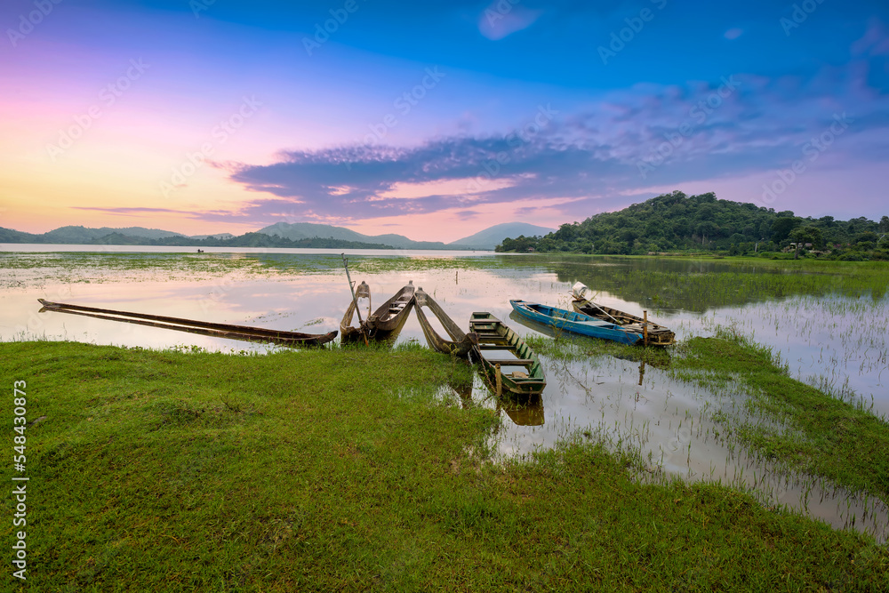 Wooden boats moored at Lak lake during dawn. Dak Lak province, Vietnam.