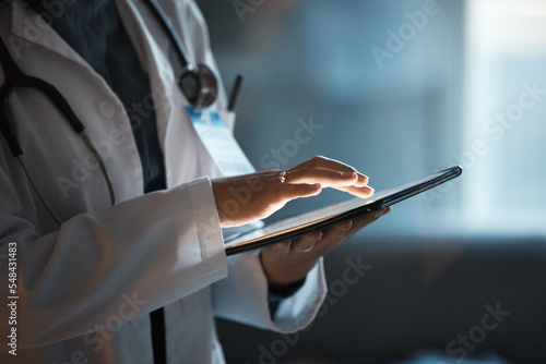 Foto Telehealth, digital tablet and doctor hands for hospital innovation, software management and results update in dark workplace