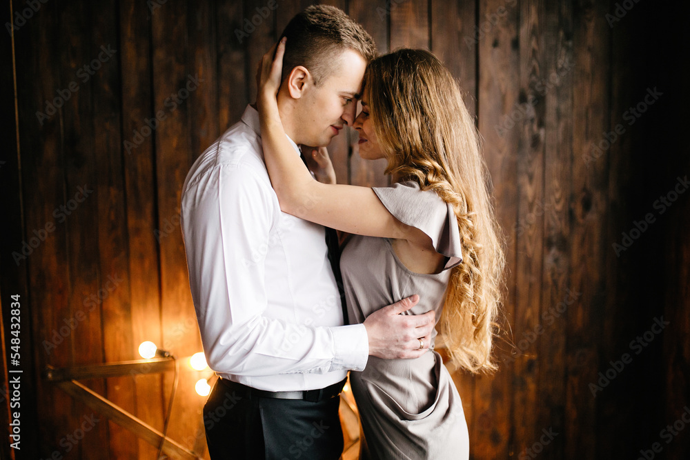 Happy smiling family at  studio on background of the Christmas tree with gift