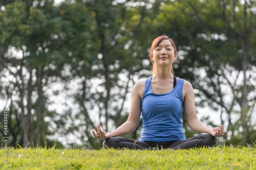 Young Asian woman in yoga suit relaxingly practicing meditation in the forest to attain happiness from inner peace wisdom for breathing exercise, healthy mind and soul concept Young Asian woman in yoga suit relaxingly practicing meditation in the forest to attain happiness from inner peace wisdom for breathing exercise, healthy mind and soul concept