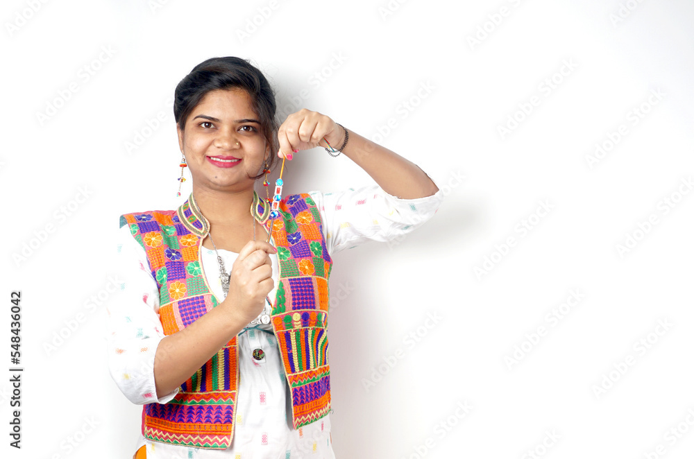 Beautiful Indian girl showing Rakhis and the gift box on the occasion of Raksha Bandhan. Sister ties Rakhi as a symbol of intense love for her brother. Beautiful Indian girl showing Rakhis and the gift box on the occasion of Raksha Bandhan. Sister ties Rakhi as a symbol of intense love for her brother.