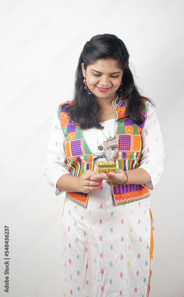 Beautiful Indian girl showing Rakhis and the gift box on the occasion of Raksha Bandhan. Sister ties Rakhi as a symbol of intense love for her brother. Beautiful Indian girl showing Rakhis and the gift box on the occasion of Raksha Bandhan. Sister ties Rakhi as a symbol of intense love for her brother.