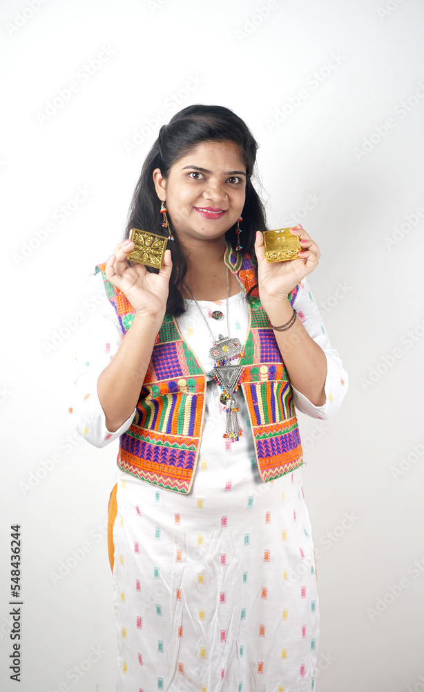 Beautiful Indian girl showing Rakhis and the gift box on the occasion of Raksha Bandhan. Sister ties Rakhi as a symbol of intense love for her brother. Beautiful Indian girl showing Rakhis and the gift box on the occasion of Raksha Bandhan. Sister ties Rakhi as a symbol of intense love for her brother.