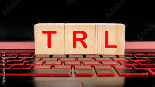 The word TRL is made of wooden blocks on a laptop keyboard photo