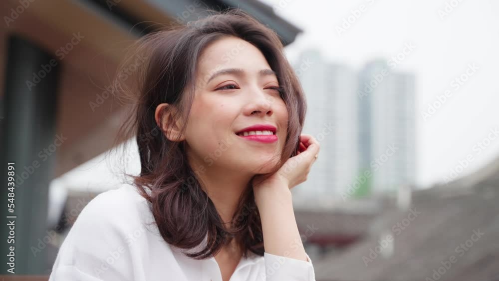 Close up of charming young asian lady relax enjoy the urban view dreaming about bright future at Chengdu China Close up of charming young asian lady relax enjoy the urban view dreaming about bright future at Chengdu China