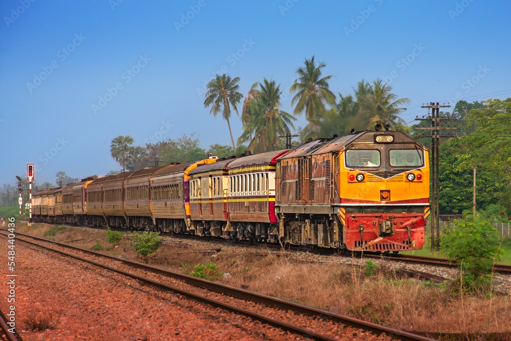 Fototapeta premium Passenger train by diesel locomotive on the railway.