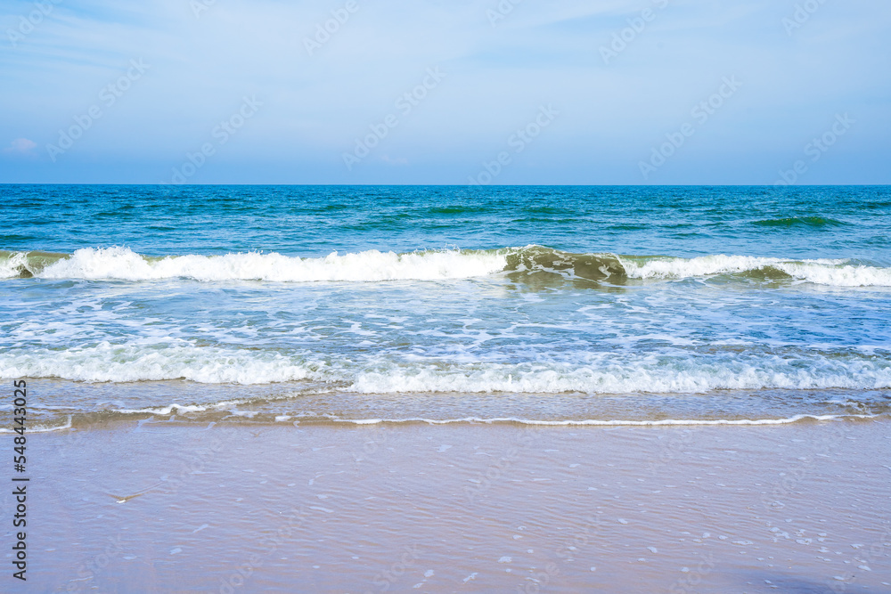 Light blue sea waves on a clean sandy beach.. Light blue sea waves on a clean sandy beach..