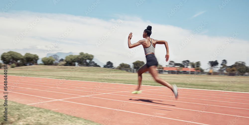 Runner, fitness and fast black woman in stadium for professional race, competition or training. Sprint, performance and champion running athlete on sport ground with blur speed movement or motion.