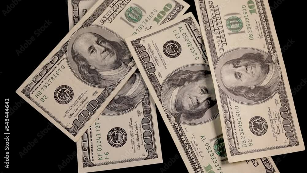 Falling money - 100 dollar bills on black background Falling money - 100 dollar bills on black background
