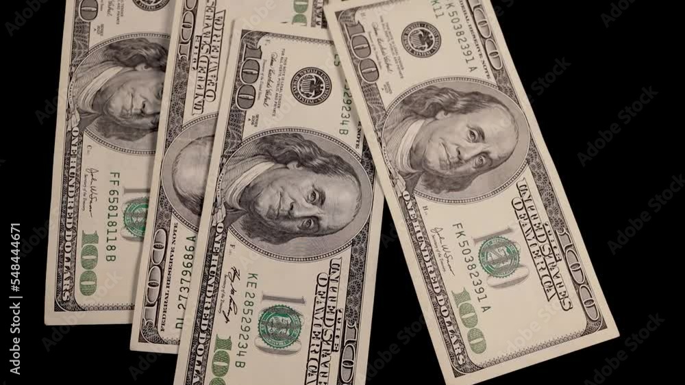 Falling money - 100 dollar bills on black background Falling money - 100 dollar bills on black background