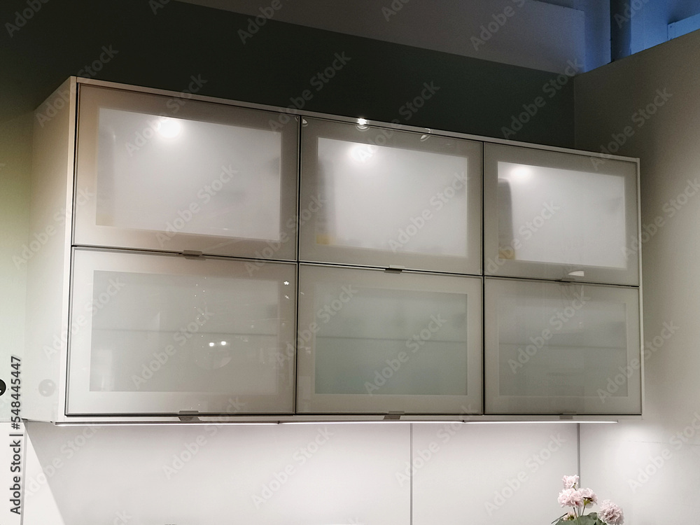 Wall cabinets in the interior of a white kitchen. Wall cabinets in the interior of a white kitchen.