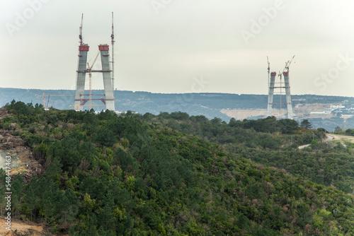 Canvas Print bridge construction rises above the forest in istanbul