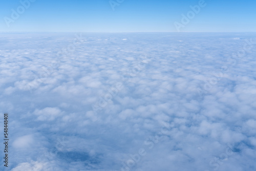 Background of a pink purple heavenly sky with fluffy dense clouds, top view from an airplane. Sky Gradient. Can be used as advertising background, overlay. Travel concept.