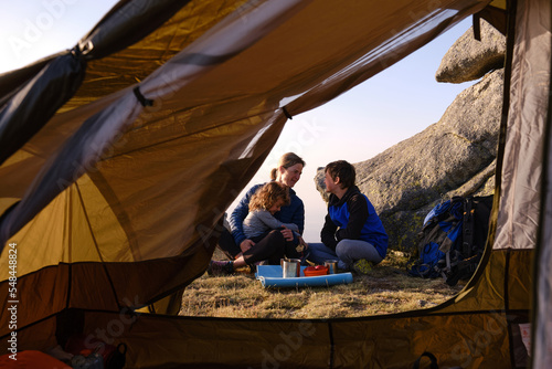 Family enjoying their camping trip in the mountains. © roberjzm