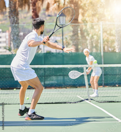 Tennis, man and woman training for fitness as a couple outdoors in a game or practice match in summer. Wellness, focus and healthy person playing sports on a tennis court in a workout or exercise