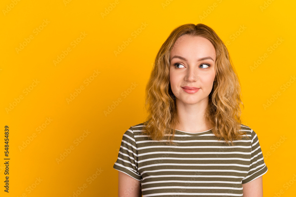 Photo of lady looking up empty space deep thinking creative wear casual t shirt isolated yellow color background Photo of lady looking up empty space deep thinking creative wear casual t shirt isolated yellow color background