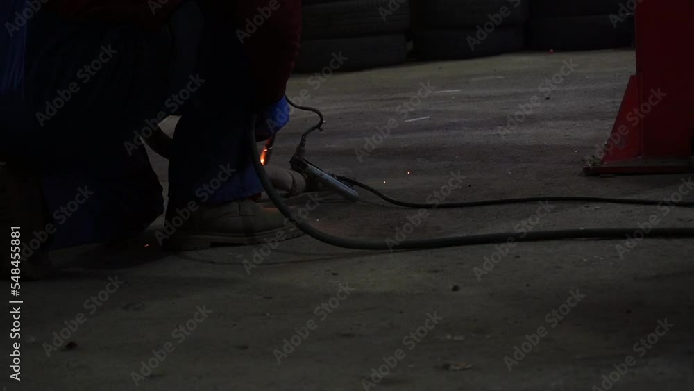the welder performs welding works of metal structures for custom cars the welder performs welding works of metal structures for custom cars