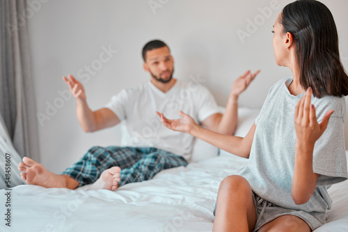 Confused, conflict and fight of couple in bedroom with doubt, liar and trust problem in marriage. Frustrated, questioning and angry people on bed in discussion on cheating, divorce and decision.