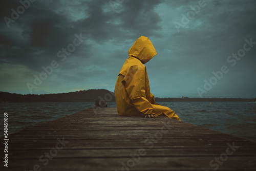 Hooded person with yellow jacket