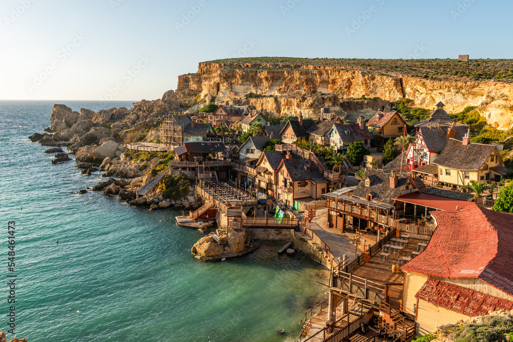 Famous Popeye Village in Anchor Bay, Mellieha, Malta. Turquoise sea water and blue sky.