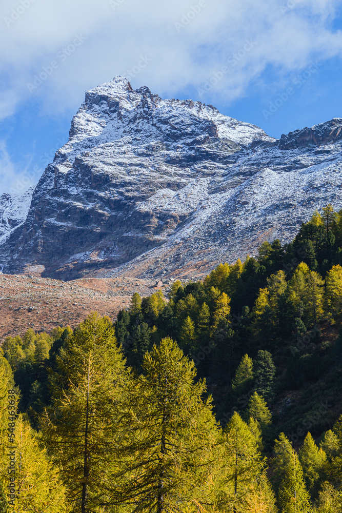 The mountains of the Val di Camp, a small valley near the village of Poschiavo, during an autumn day, Canton of Grisons, Switzerland - October 2022. The mountains of the Val di Camp, a small valley near the village of Poschiavo, during an autumn day, Canton of Grisons, Switzerland - October 2022.