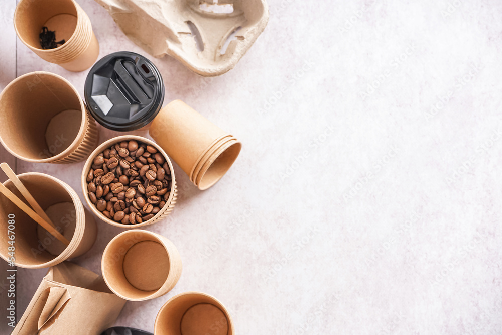 Different paper cups and coffee beans on light background Different paper cups and coffee beans on light background