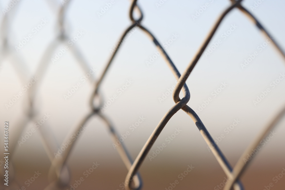 Metal chain links wire-mesh rabitz on blurred background