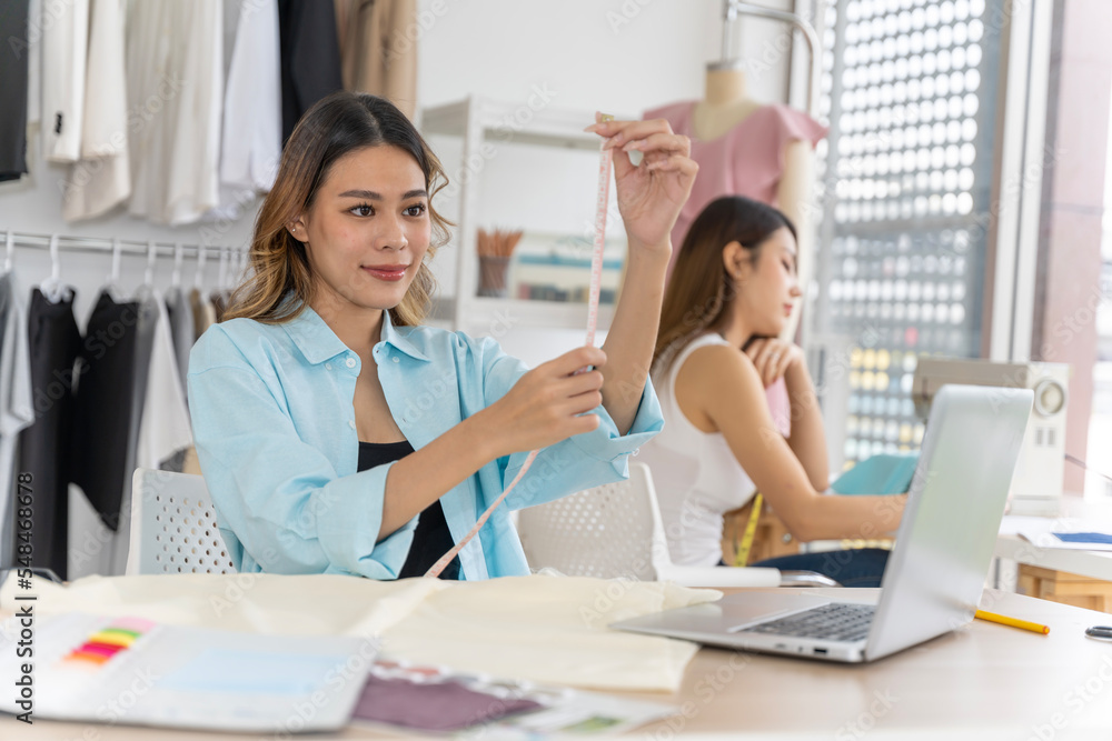 Two Asian women working together Small business, SME, tailoring designs for customers. Both of them acted as great designers. Two Asian women working together Small business, SME, tailoring designs for customers. Both of them acted as great designers.