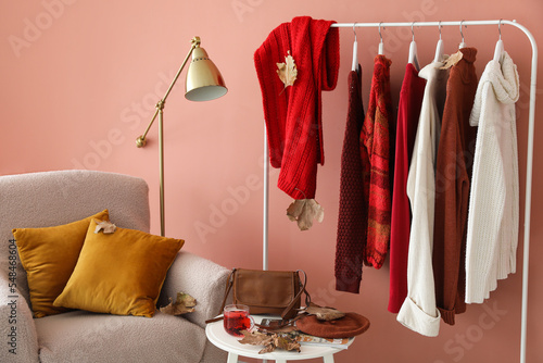 Rack with warm sweaters in ...