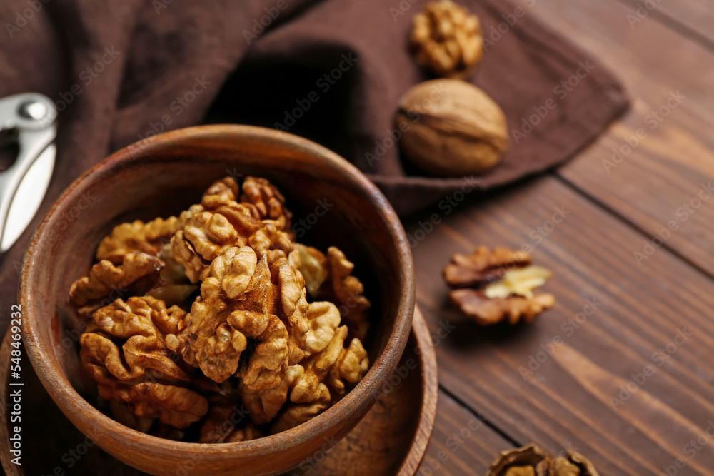 Bowl of walnut kernels on wooden table, closeup Bowl of walnut kernels on wooden table, closeup