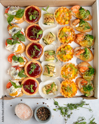 assorted snacks for catering in a cardboard box