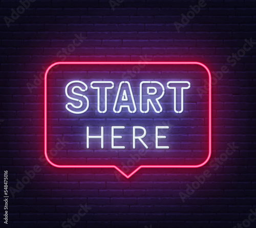 Start Here neon sign in the speech bubble on brick wall background.