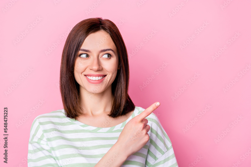 Photo of cheerful gorgeous cute girl with bob hairstyle wear striped t-shirt indicating look empty space isolated on pink color background Photo of cheerful gorgeous cute girl with bob hairstyle wear striped t-shirt indicating look empty space isolated on pink color background