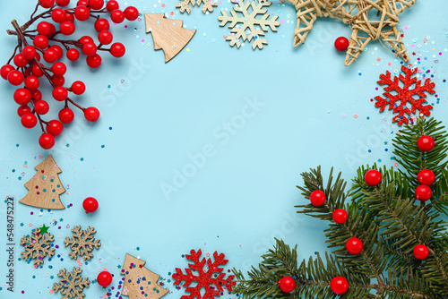 Frame made of Christmas decorations and fir branch on color background