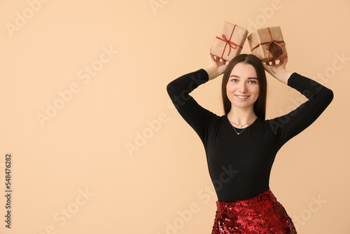 Smiling young woman holding...