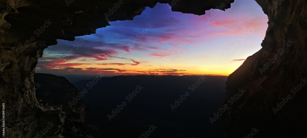 Mountain views to sunset from inside cliff cave