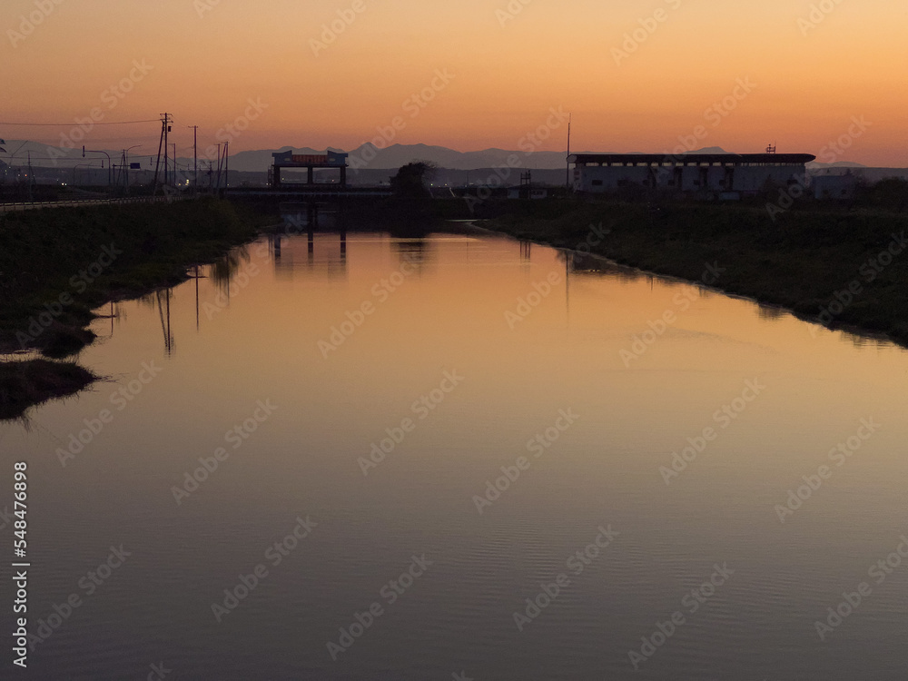 Irrigation canal reflecting the sunset