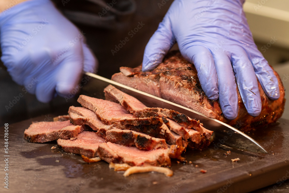 man chef cuts cooked fried meat