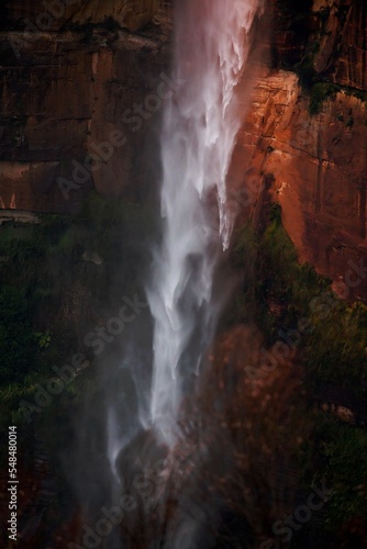 Powerful waterfall tumbling over sandstone cliffs