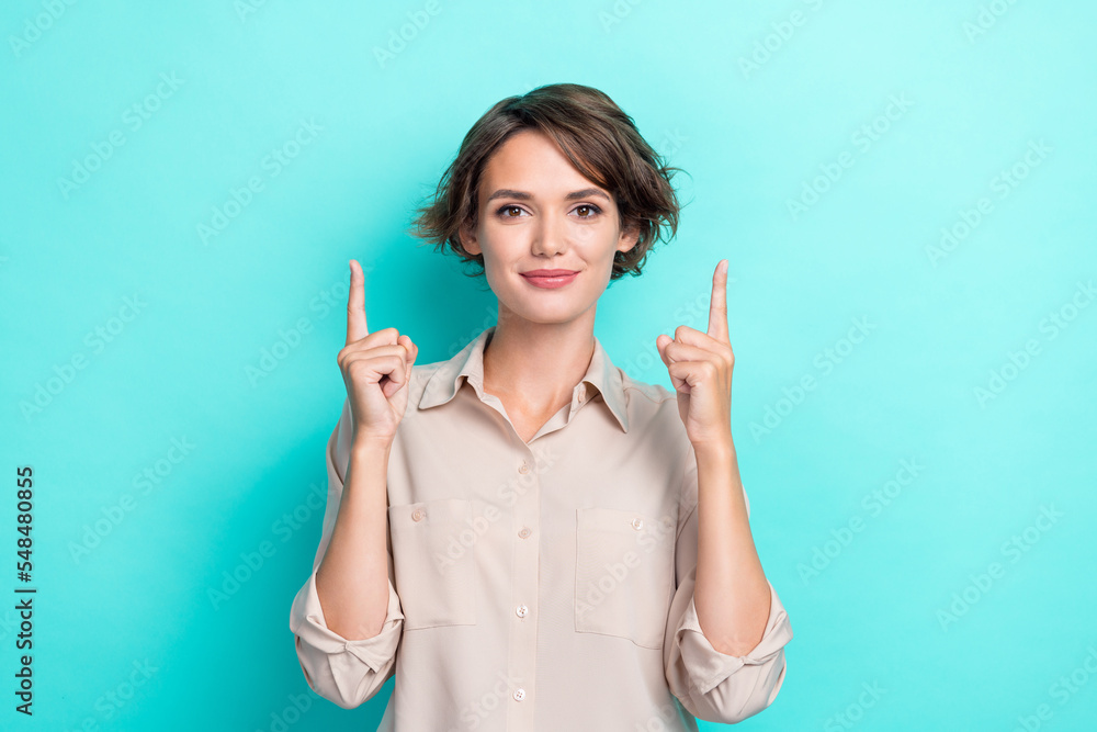 Portrait photo of young confident business lady wear beige shirt fingers directing up empty space genius solution isolated on aquamarine color background Portrait photo of young confident business lady wear beige shirt fingers directing up empty space genius solution isolated on aquamarine color background